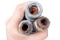 a person holding three pipes that are blocked with limescale and rust