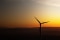 A windmill in front of a sunset