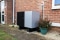 compact  sleek-looking vitocal 151-a outdoor unit has been situated near a north-facing wall at the front of the house.