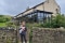 Cronkshaw Fold Farm exterior with owner of farm holding her baby