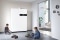 The picture shows two boys playing in front of a Viessmann Vitovalor PT2.